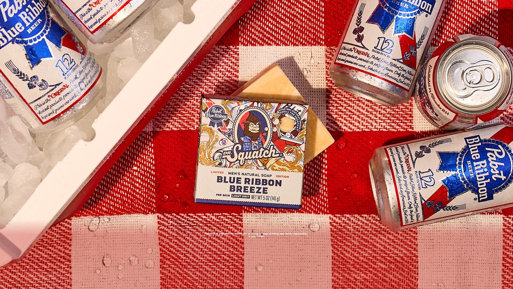 blue ribbon breeze soap features on a picnic table next to a cooler and cans of PBR