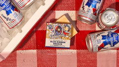 blue ribbon breeze soap features on a picnic table next to a cooler and cans of PBR