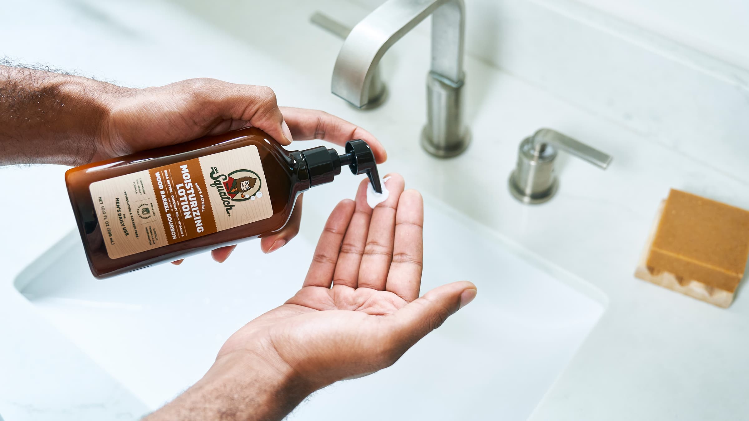 Dr. Squatch Wood Barrel Bourbon Lotion being used